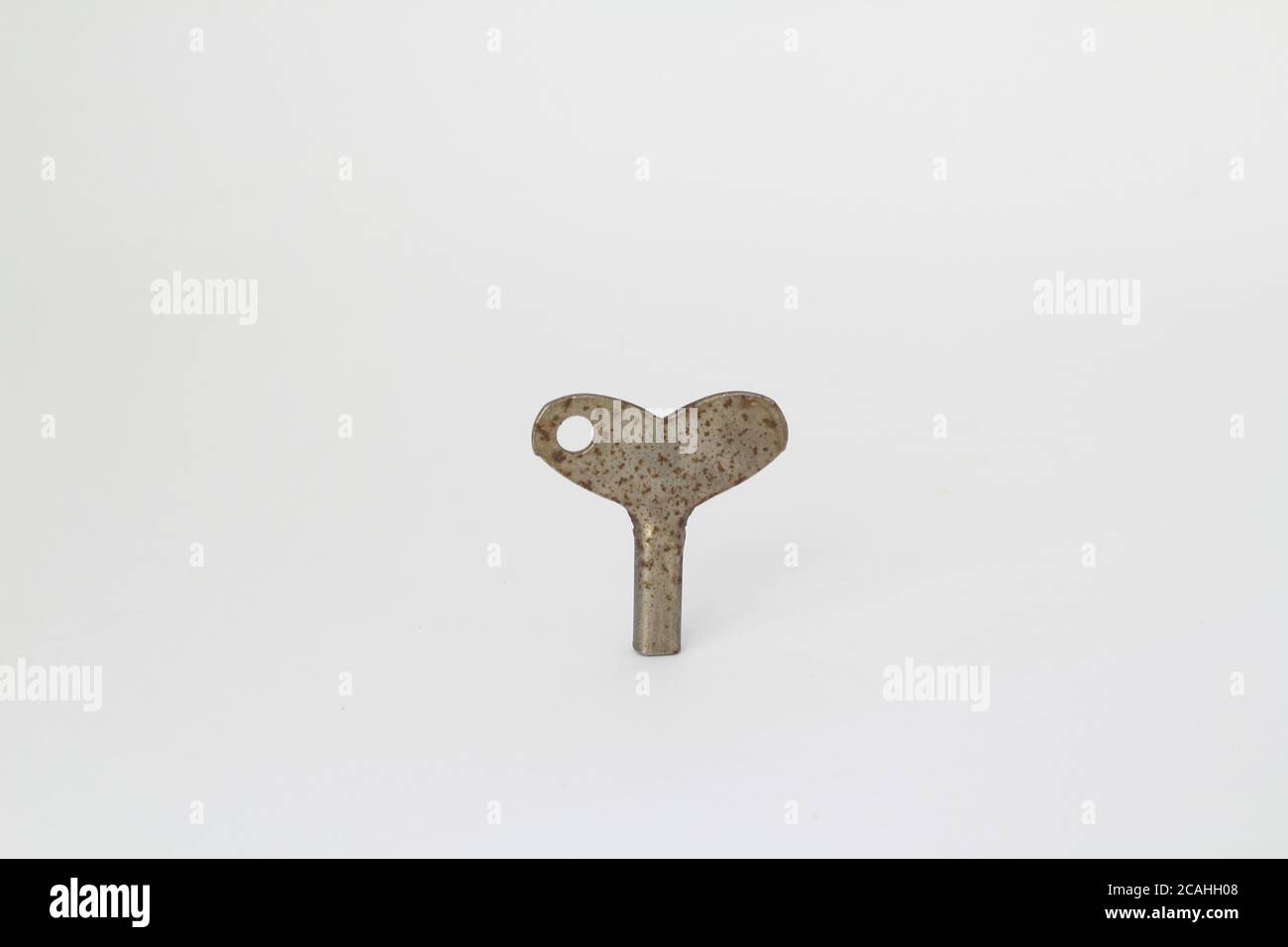 Old rusty antique key on white background Stock Photo - Alamy