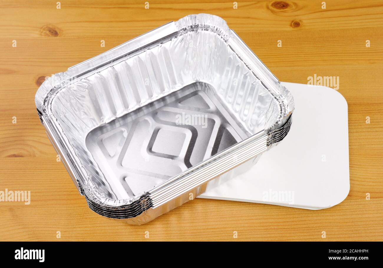 Aluminium foil take away trays on a wooden background Stock Photo Alamy