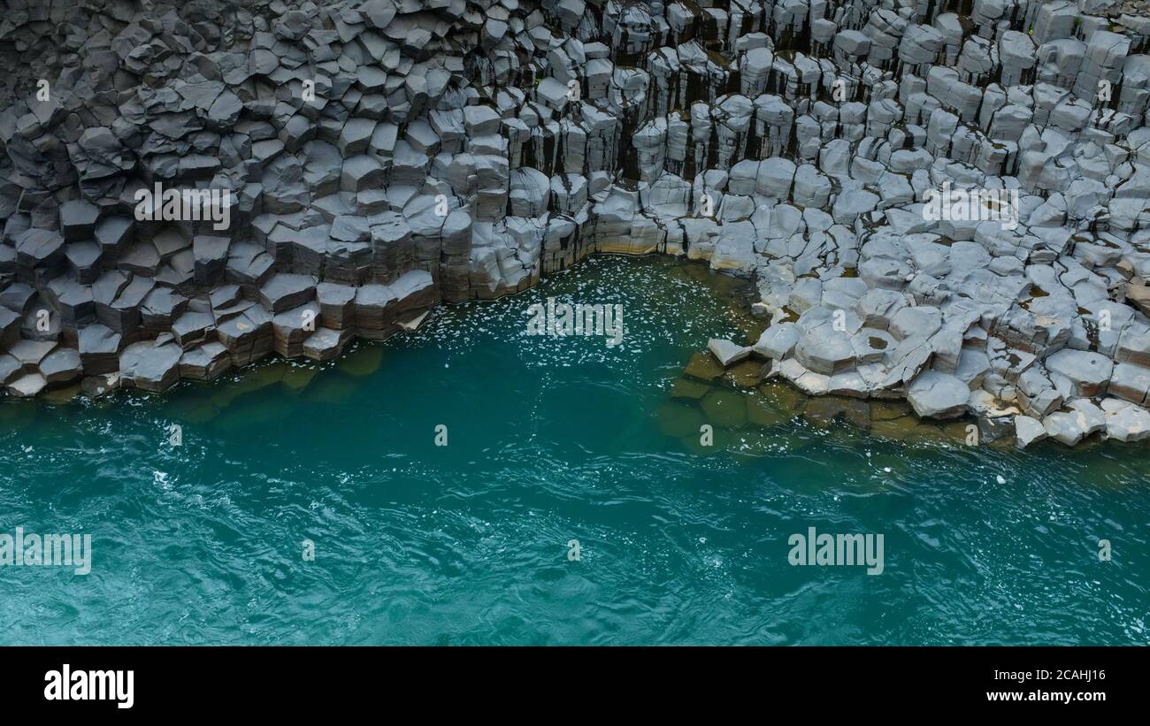 Turquoise Blue water and Basalt Columns at Studlagil Basalt Canyon in East Iceland Stock Photo