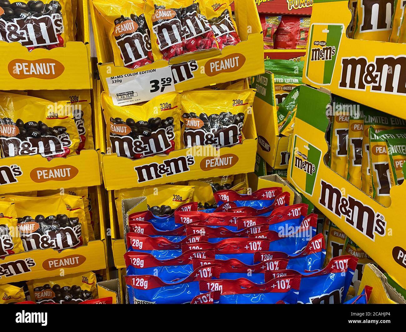 Viersen, Germany - July 9. 2020: View on stack with yellow M&M chocolate products in german supermarket Stock Photo