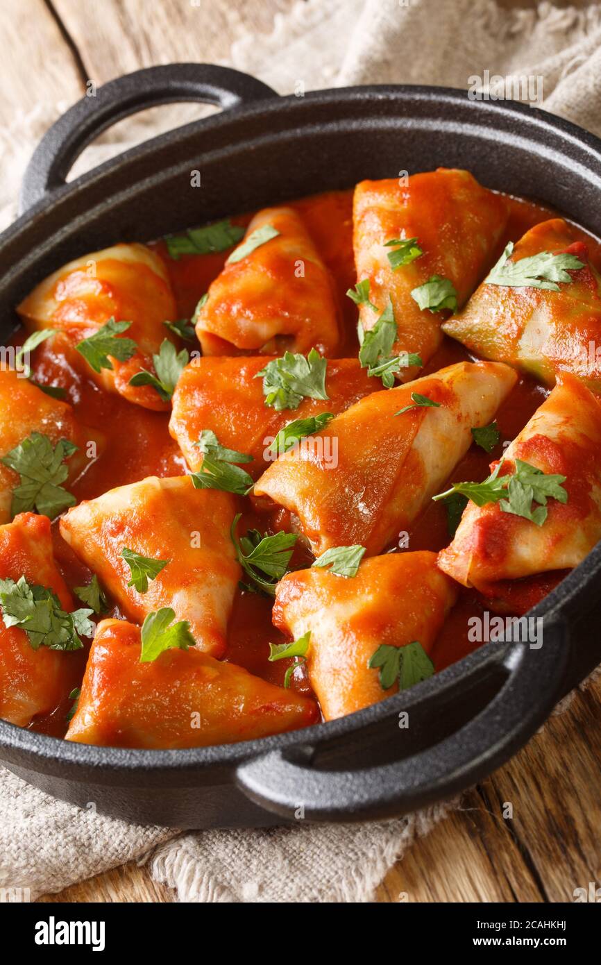Ukrainian national dish cabbage rolls with meat and rice close-up in a bowl on the table. vertical Stock Photo