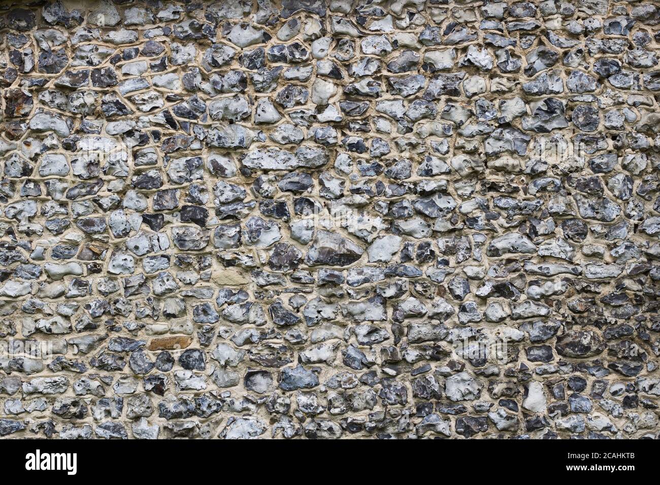 Grey flint wall background showing texture with space for copy Stock Photo