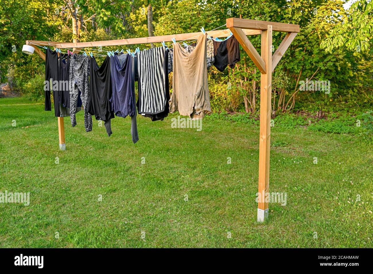 clothes hanging to dry on home made drying rack Stock Photo