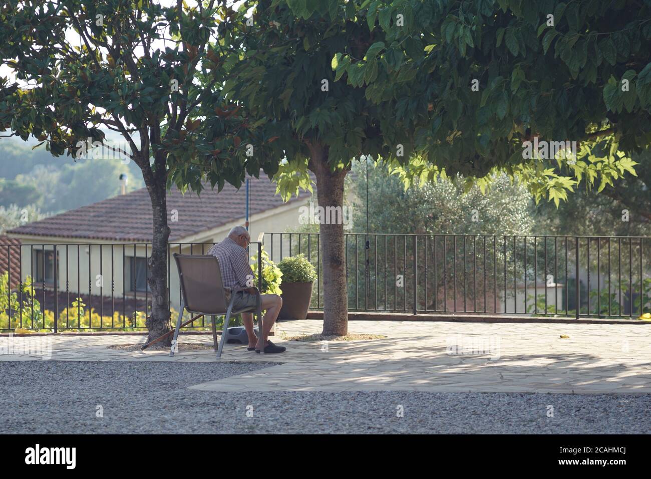 Shot of a lonely old man sitting on a chair in a park Stock Photo - Alamy