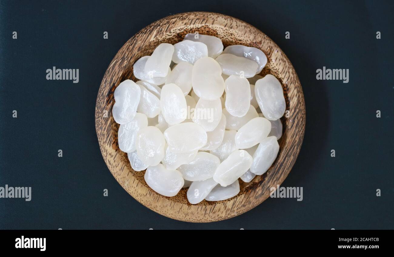 Sugar palm fruit on wooden plate on black background. Stock Photo