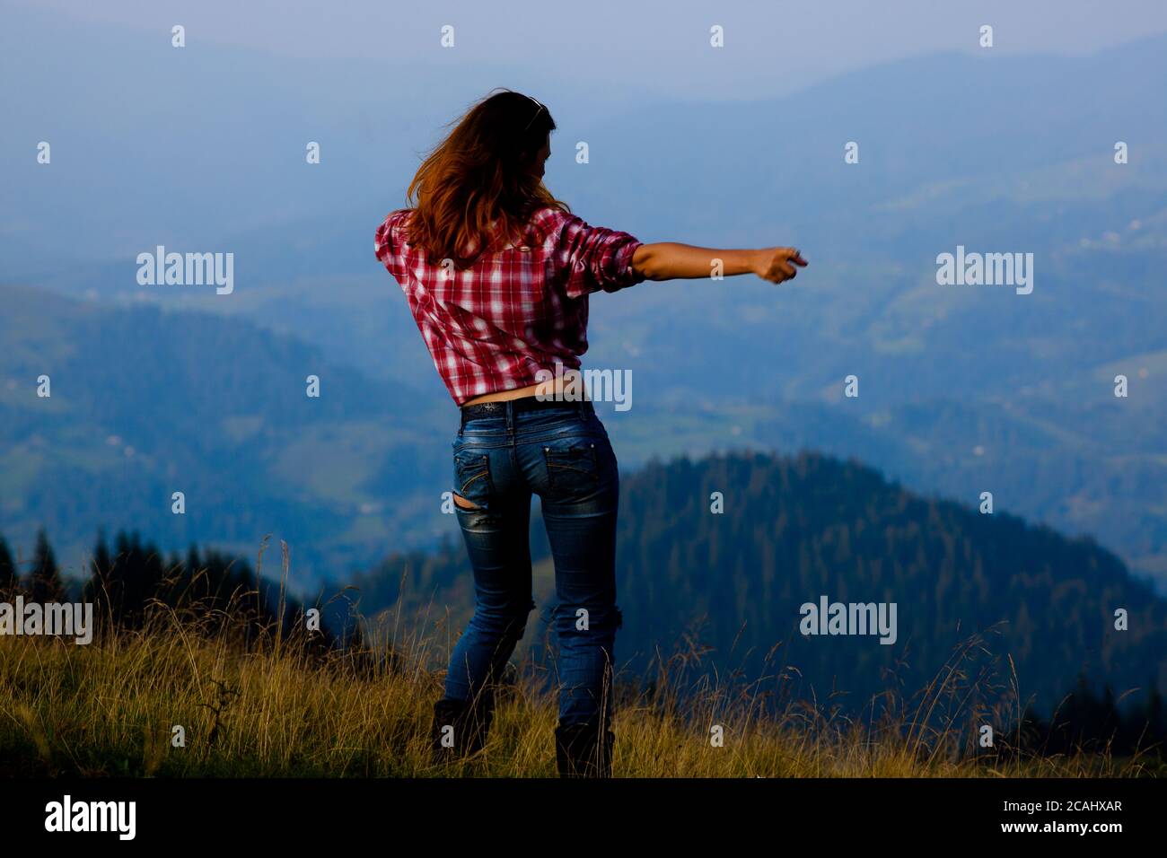 girl tourist high in the mountains sunset sun fog tops of the carpathians Stock Photo