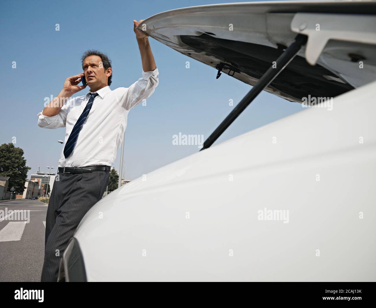 Car Driver With Engine Breakdown Calling Insurance Stock Photo