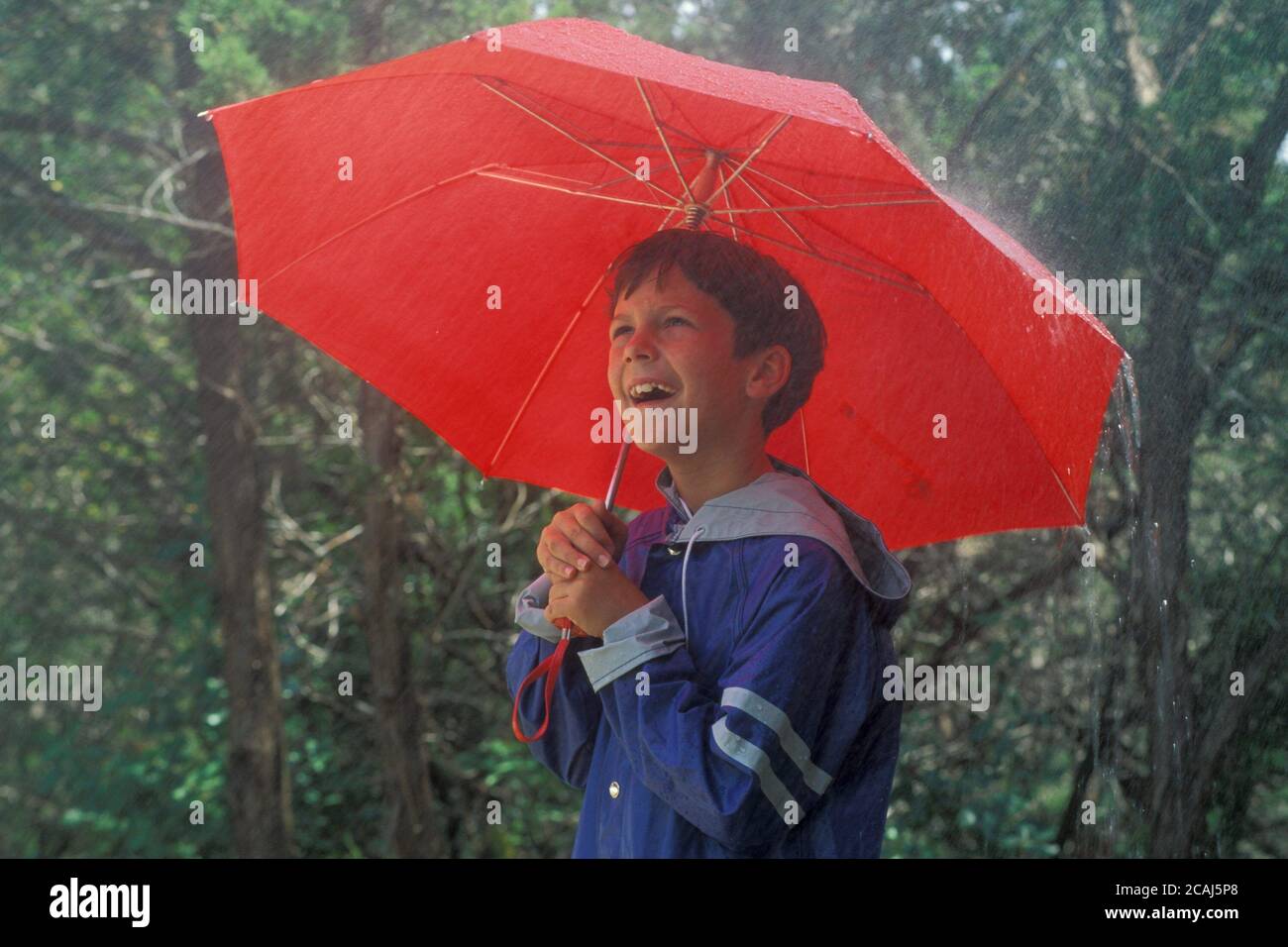 Young boy in raincoat outside hires stock photography and images Alamy
