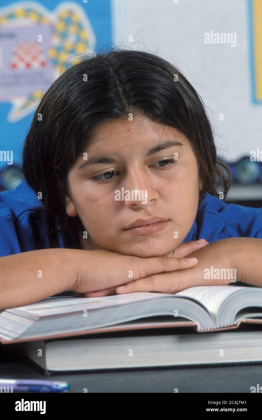 Hispanic middle-school girl rests during class. Model Release. ©Bob ...