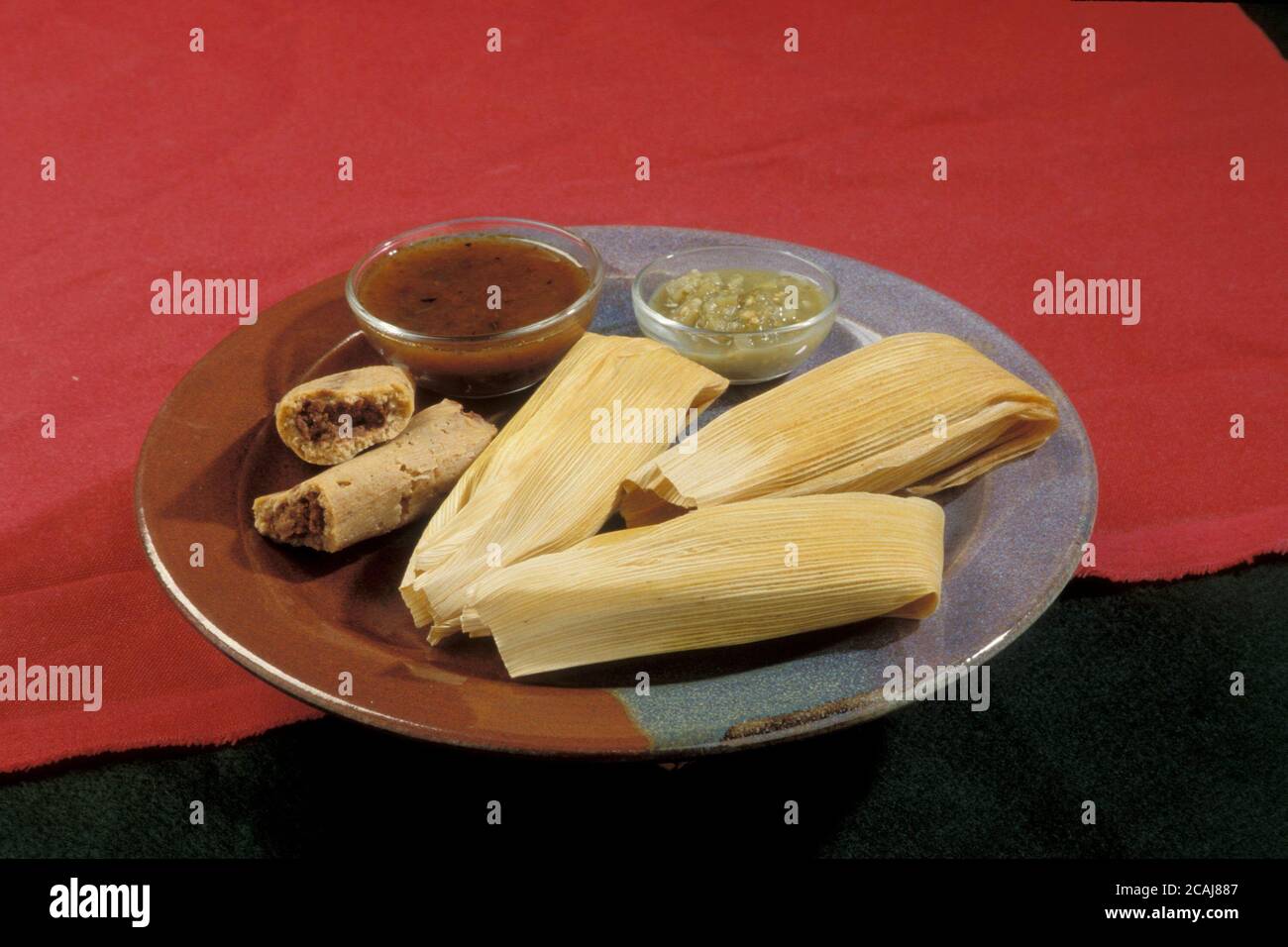 Plateful of bean tamales with salsa verde and salsa rojo. ©Bob Daemmrich Stock Photo