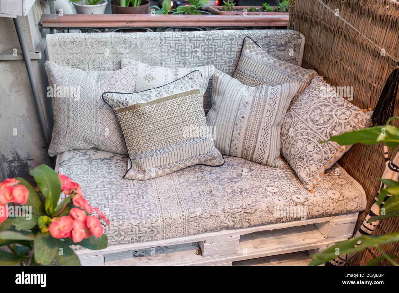 https://c8.alamy.com/comp/2CAJB3P/comfy-couch-with-pillows-surrounded-by-houseplants-2CAJB3P.jpg