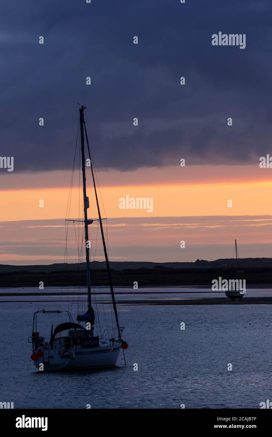 Yacht in silhouette at Ravenglass, Lake District, England Stock Photo