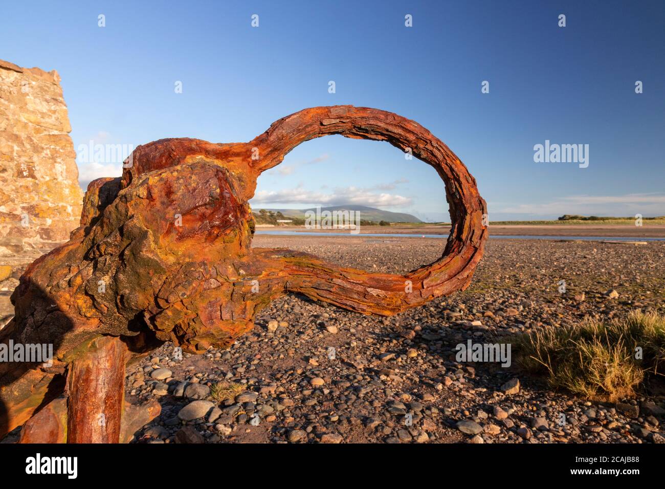 Old rusty anchor on the beach at Ravenglass, Lake District, England Stock Photo