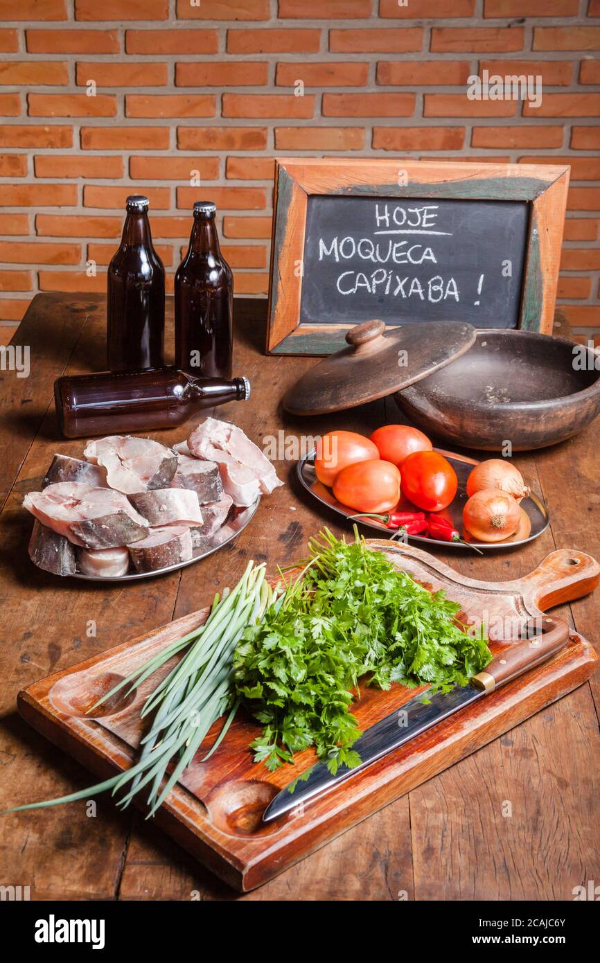 Text on blackboard written in portuguese: 'Today - Capixaba Fish Stew' - A typical dish of Espirito Santo State/ Brazil - Made with fish, tomatoes, on Stock Photo