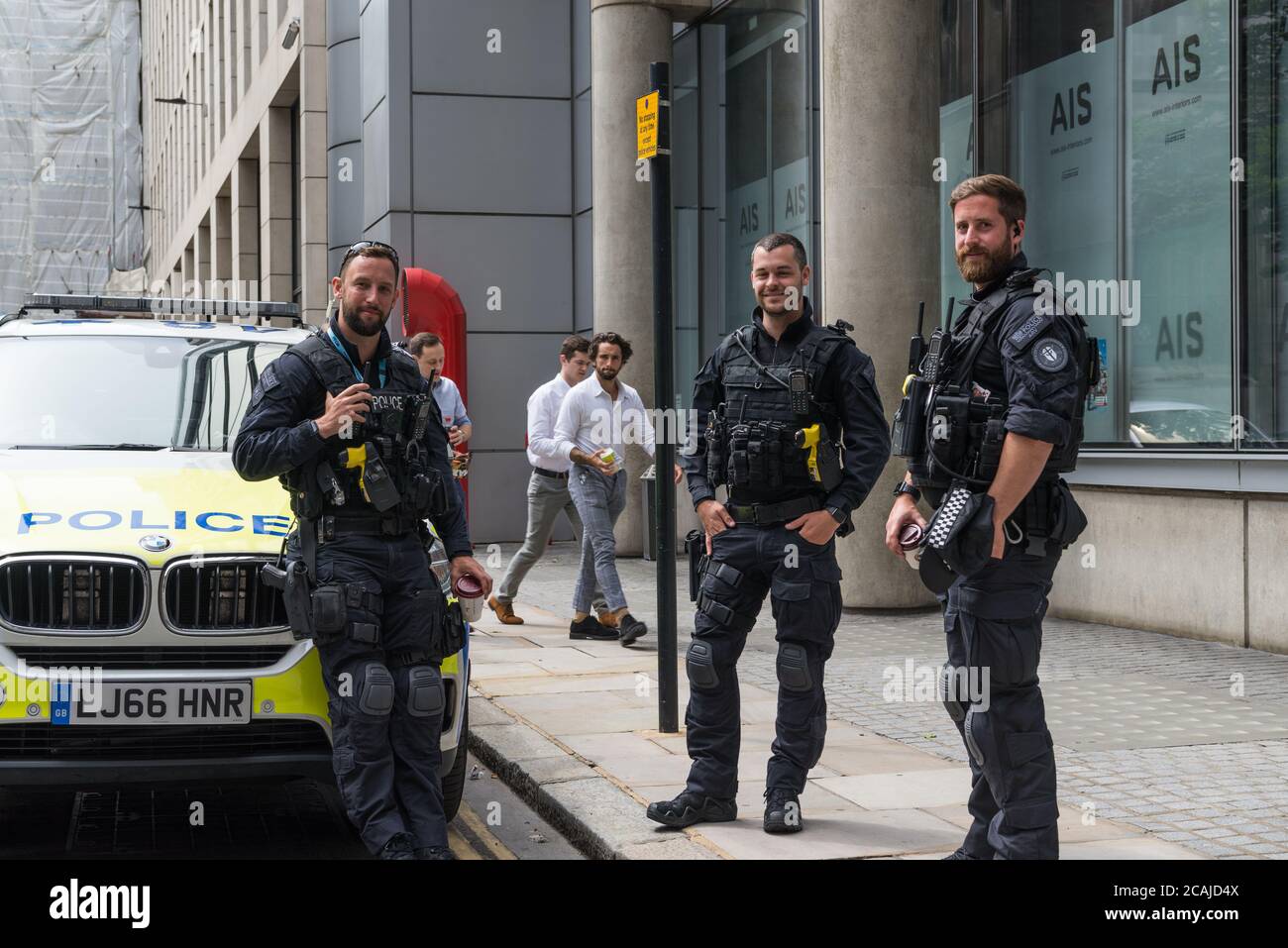 City of London armed police officers take a break and stand in