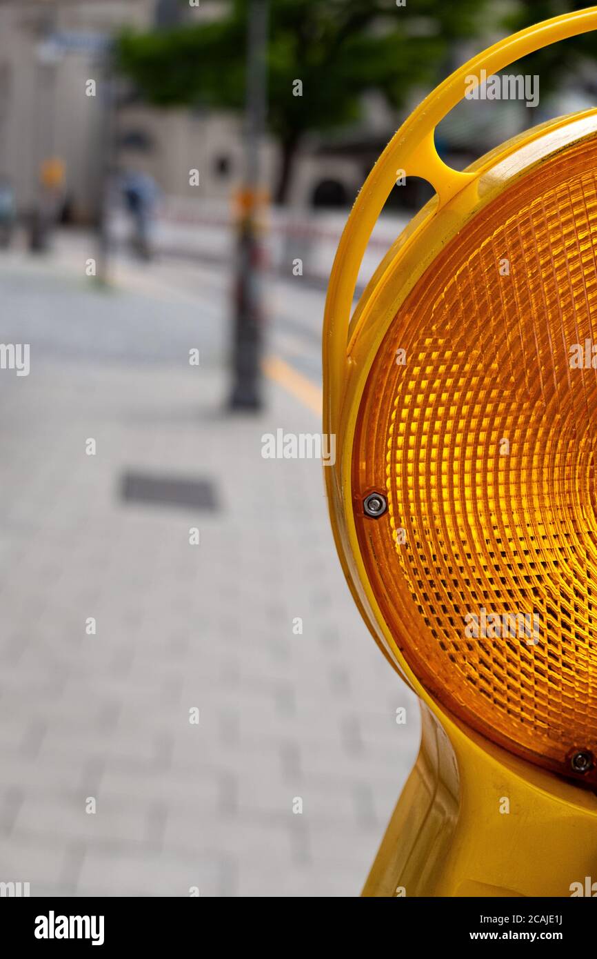close up of the half of a warning lamp on a street Stock Photo