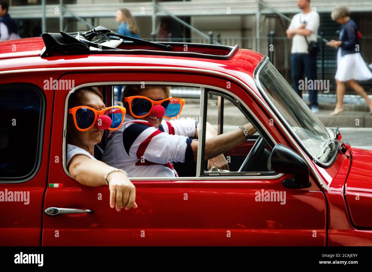 TURIN, ITALY - SEPTEMBER 24, 2017 - Funny looking couple driving an old red Fiat 500 during a classic car rally in Turin (Italy) on september 24, 2017 Stock Photo