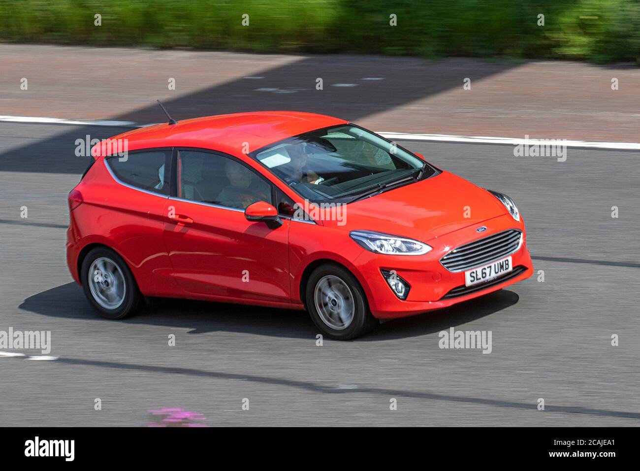 2017 (67)) red Ford Fiesta Zetec; Vehicular traffic moving vehicles, cars driving vehicle on UK roads, motors, motoring on the M6 motorway highway network. Stock Photo