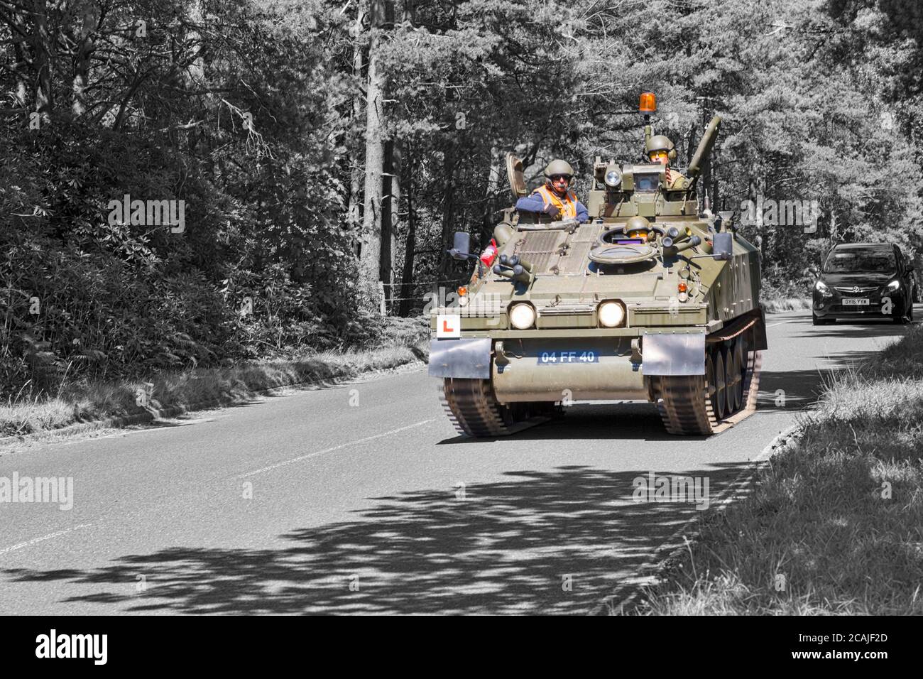 Spartan FV103 armoured vehicle with L plate learner driver, driving