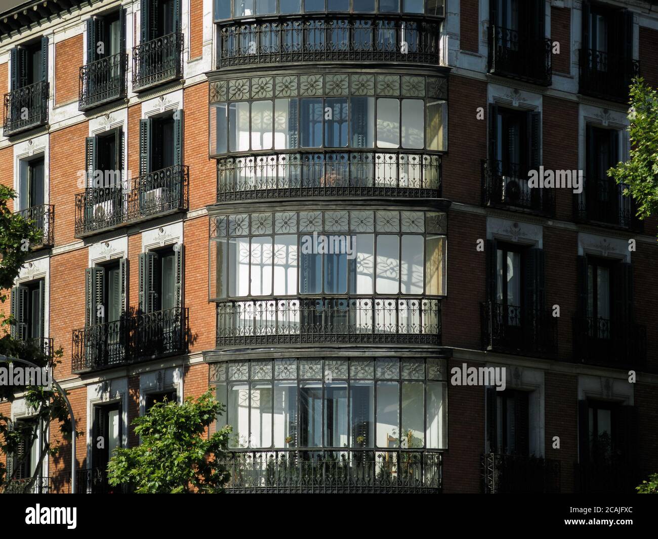 Modern brick building with balconies and windows Stock Photo - Alamy