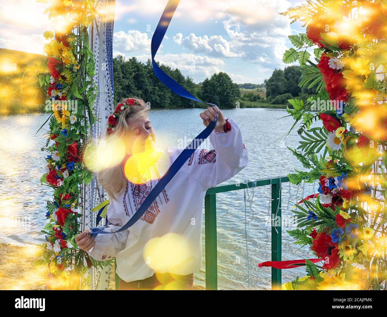 Ukrainian girl  in national costumes take part in ethno festival. Ukrainian young woman wear traditional ukrainian clothes and flower wreath in ethno Stock Photo