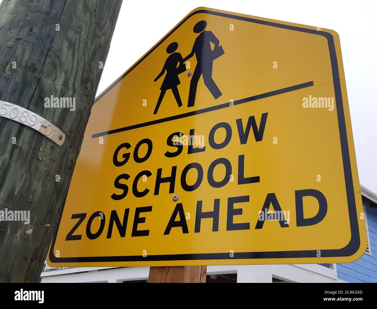 Go Slow, School zone ahead road sign. Stock Photo