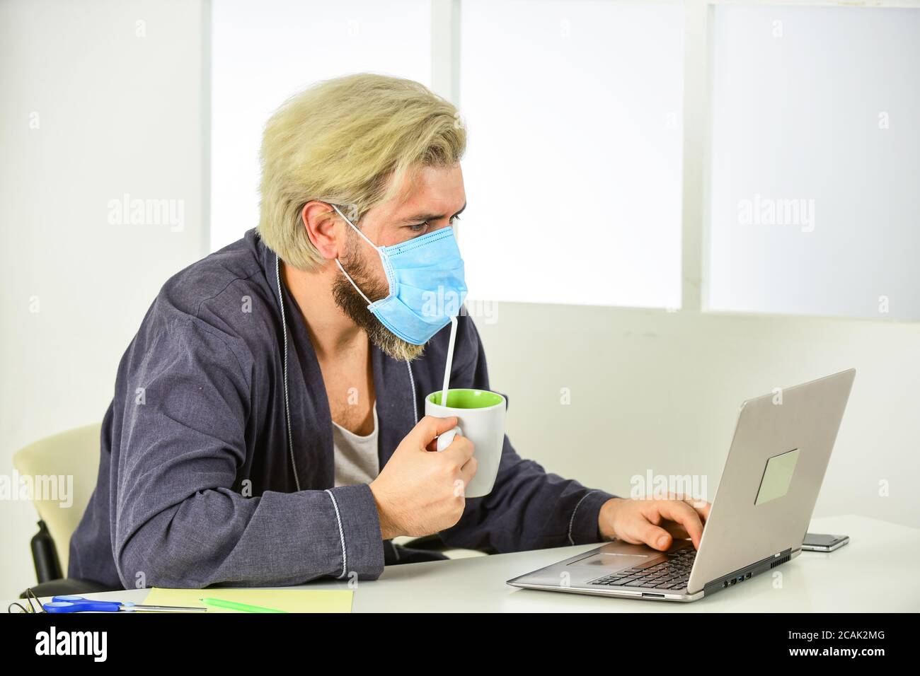 remote-based job. online shopping. man in respirator protective mask in office. work on a remote site. distance learning. infection control and prevention measures. keep your distance. Stock Photo