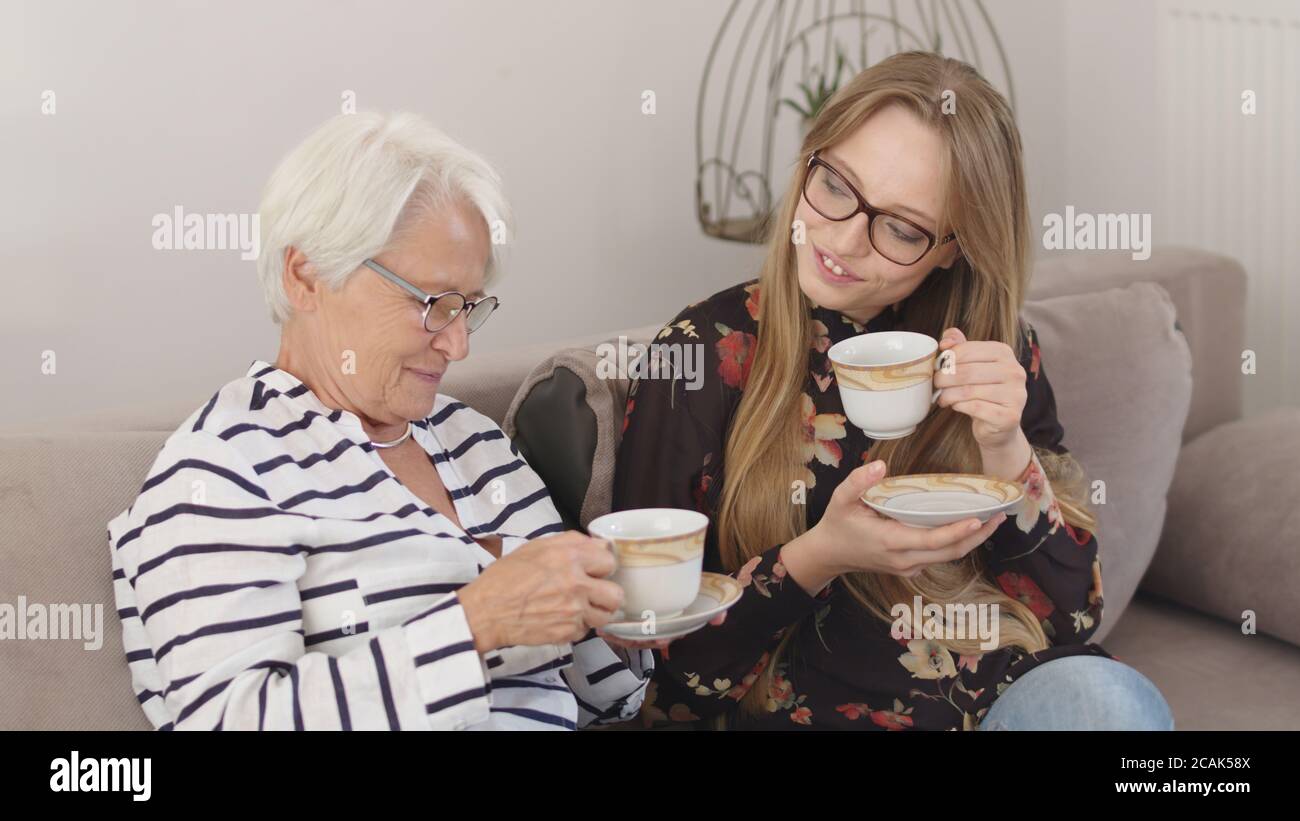 Holidays with family. Mother and daughter or granny and granddaughter having the tea together. High quality 4k footage Stock Photo