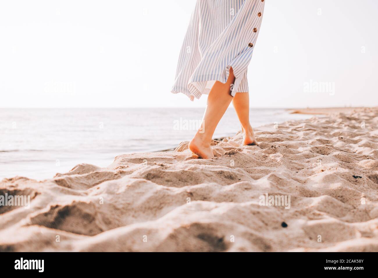 Woman alone walking barefoot hi-res stock photography and images - Alamy