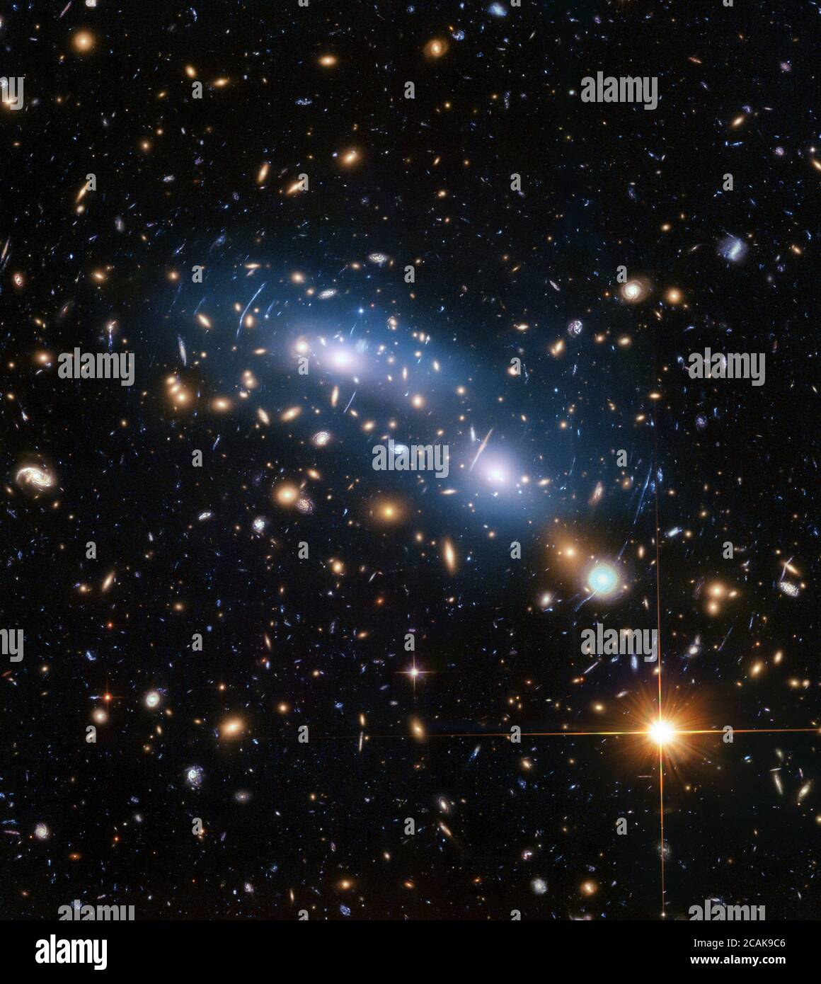 This image from the NASA/ESA Hubble Space Telescope shows the galaxy cluster MACS J0416. This is one of six being studied by the Hubble Frontier Fields programme, which together have produced the deepest images of gravitational lensing ever made. Scientists used intracluster light (visible in blue) to study the distribution of dark matter within the cluster. Stock Photo