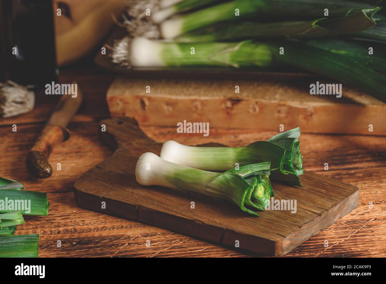 Fresh green leek on cutting board Stock Photo