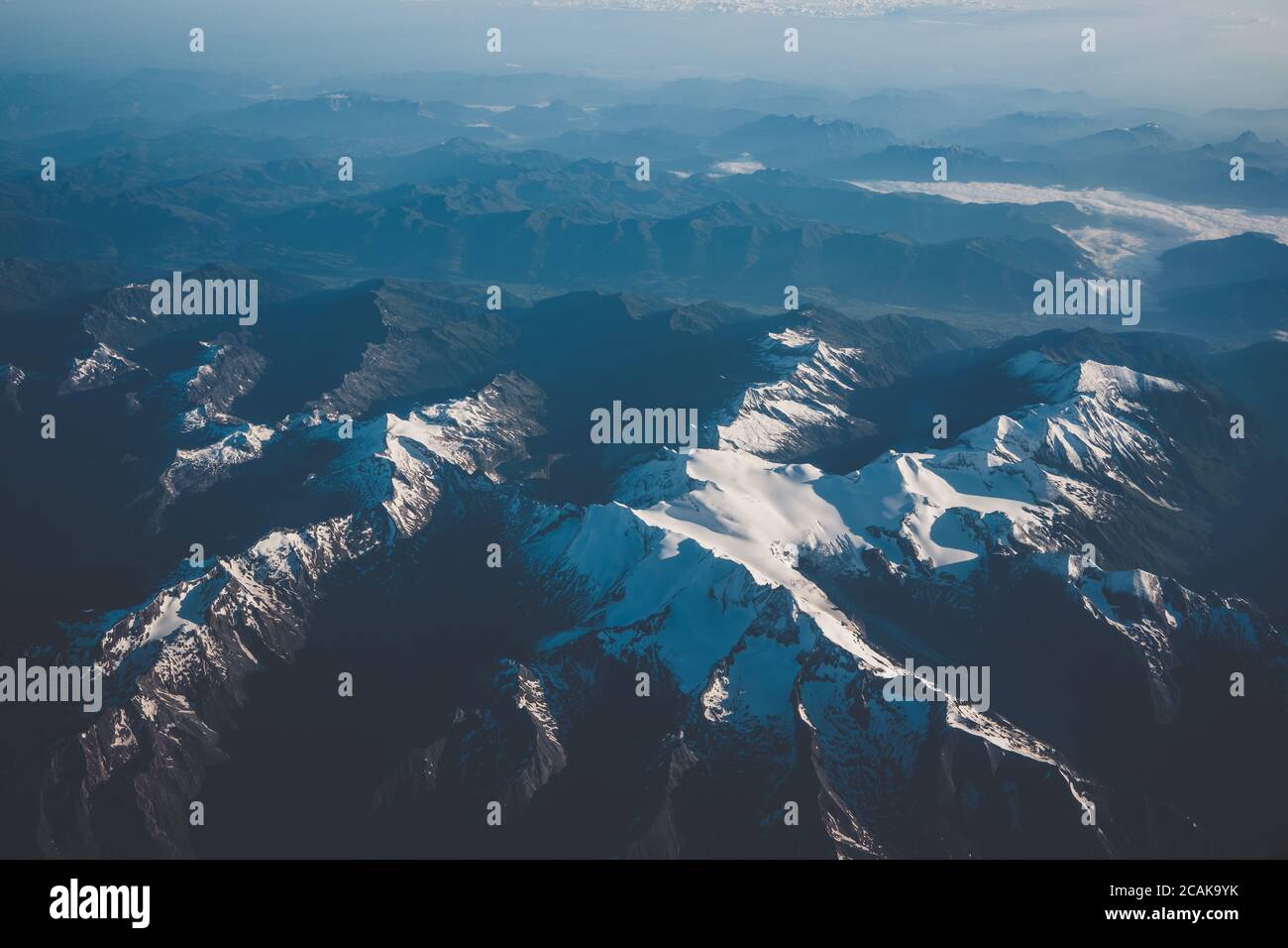 Austria view from airplane, mountains covered by clouds and beautiful ...