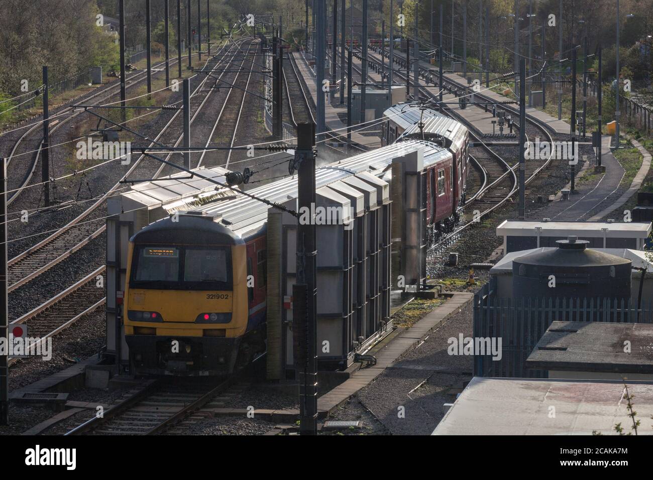 Northern rail class 321 electric train 321902 passing through the carriage washing plant at  Skipton Broughton Road carriage sidings / depot Stock Photo