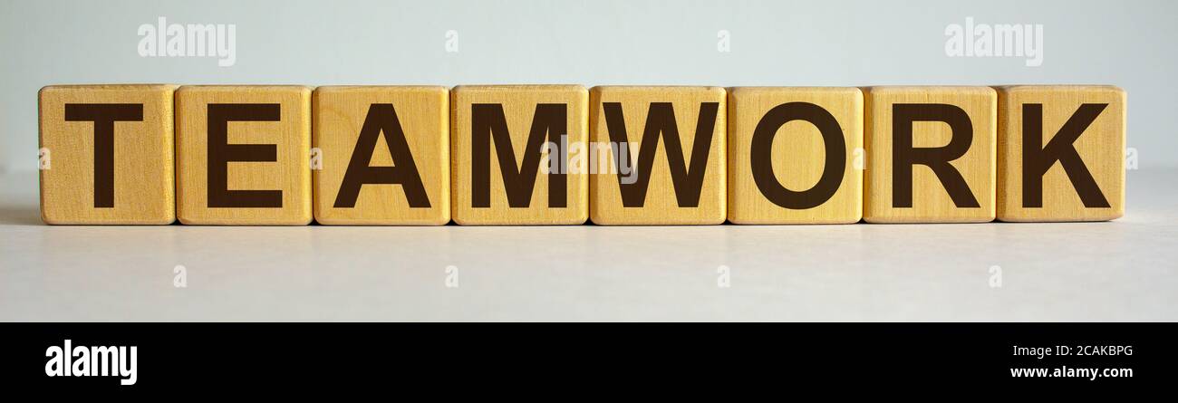 8 wooden cubes with the inscription 'teamwork'. Beautiful white ...