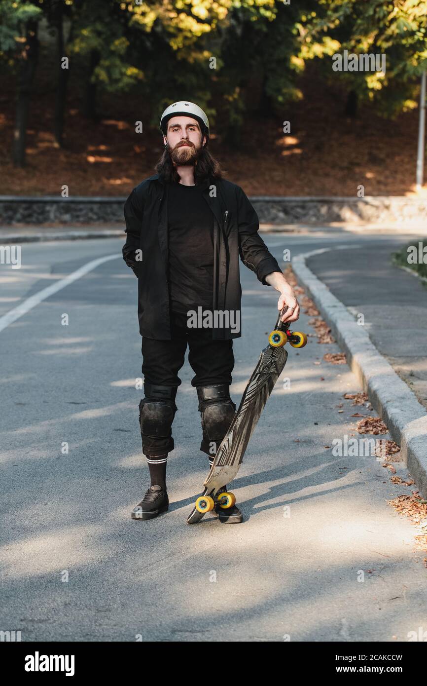 Lifestyle style of sketching, longboard. Portrait of a bearded guy with a board. Stock Photo