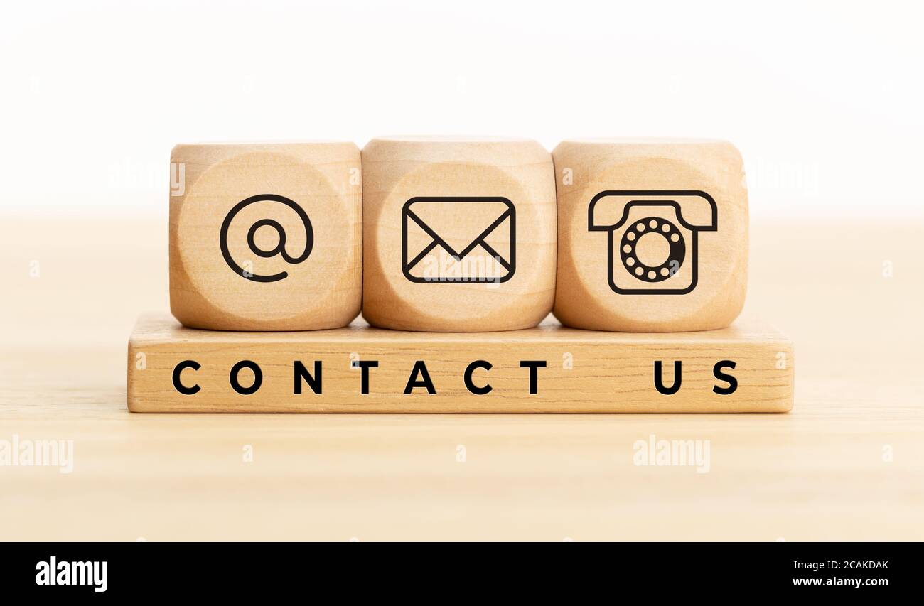 Contact us concept. Wooden blocks with email, mail and telephone icons.Website page contact us or e-mail marketing Stock Photo
