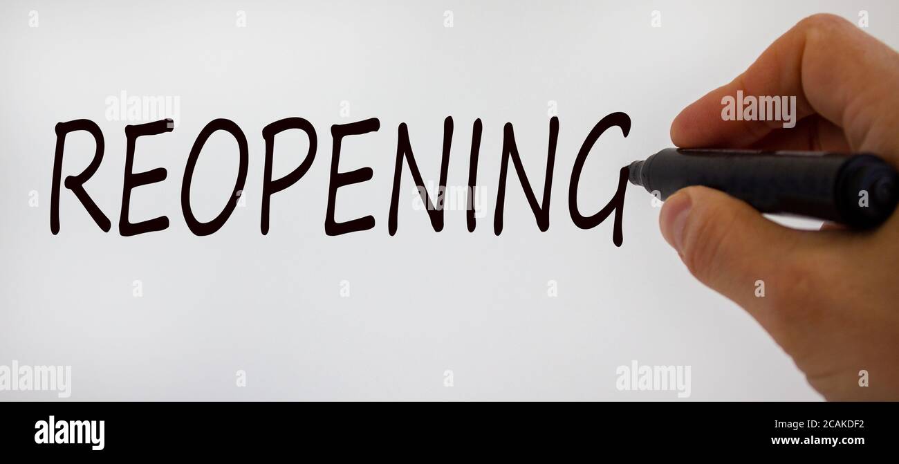 Hand writing 'reopening', isolated on beautiful white background. Concept. Stock Photo