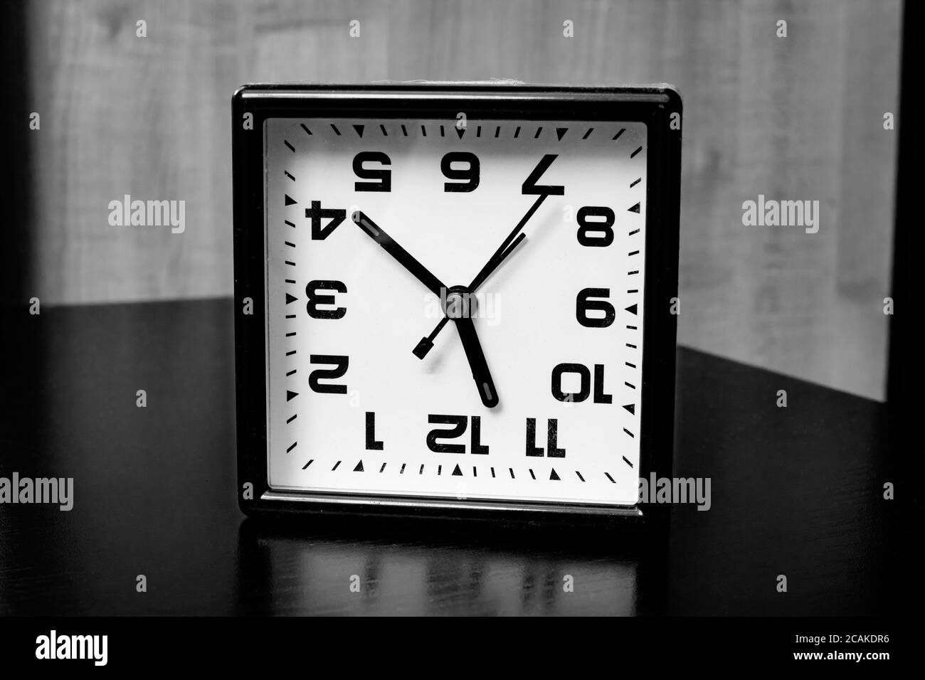 Inverted clock with arrows in black and white Stock Photo - Alamy
