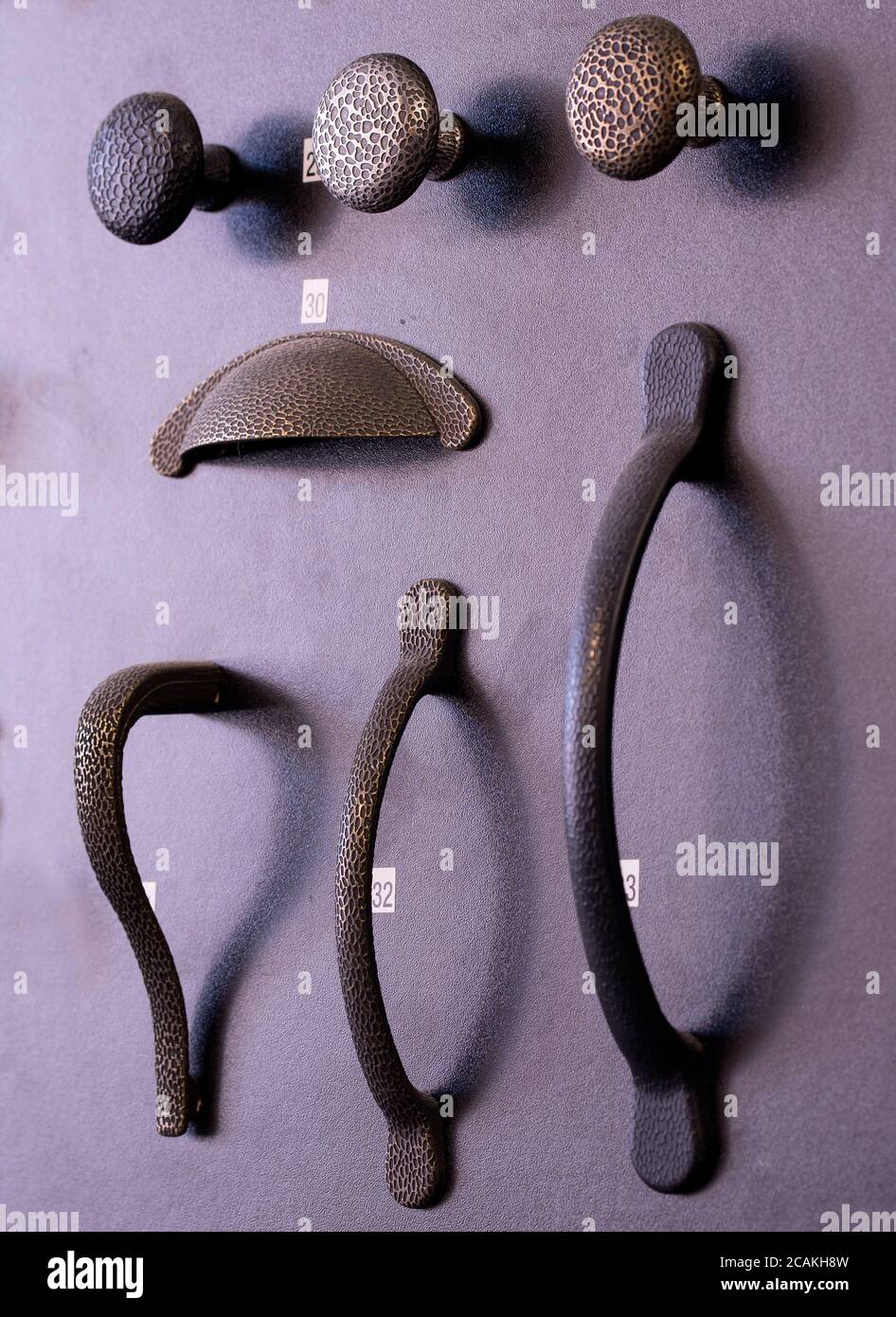 Various style cupboard door handles on display Stock Photo Alamy