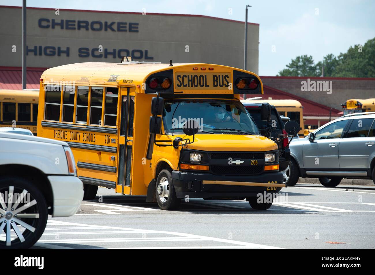 Canton, GA, USA. 7th Aug, 2020. Cherokee High School buses leave school with students at end of first week of in-person fall classes during pandemic worries. The school system mandate masks for all faculty and staff, but declined to insist students wear them. Administrators admitted the county is under a Ã”national microscopeÃ as it reopened face-to-face classes as Covid-19 cases surged in Georgia. Credit: Robin Rayne/ZUMA Wire/Alamy Live News Stock Photo