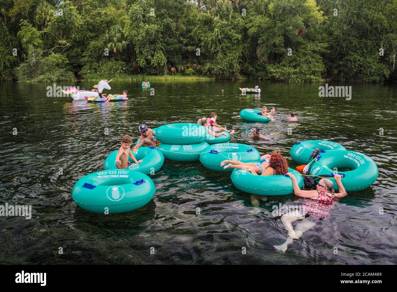 People Tubing on the Rainbow River. A spring fed scenic waterway in Dunnellon, Florida. Populat Florida tourist vacation destination. Family fun in Ma Stock Photo