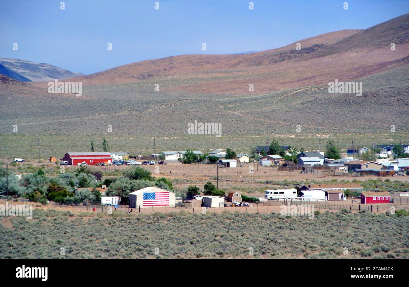 small rural  town in the nevada mountains displays patriotic american flag Stock Photo