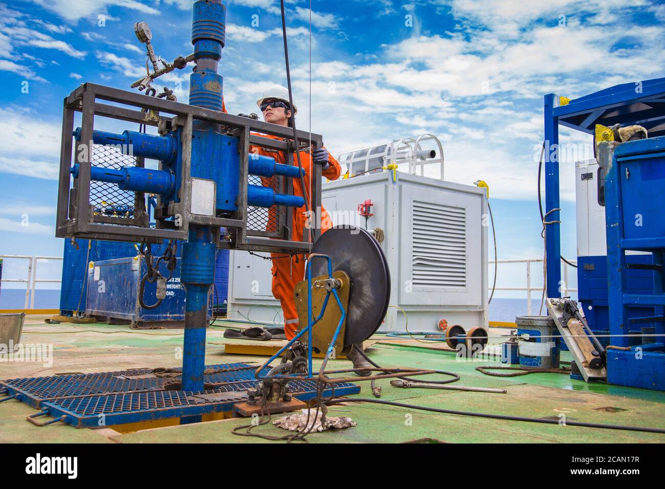 Offshore oil and gas industry, worker inspect and setting up top side tools for safety first to perforation oil and gas production well. Stock Photo