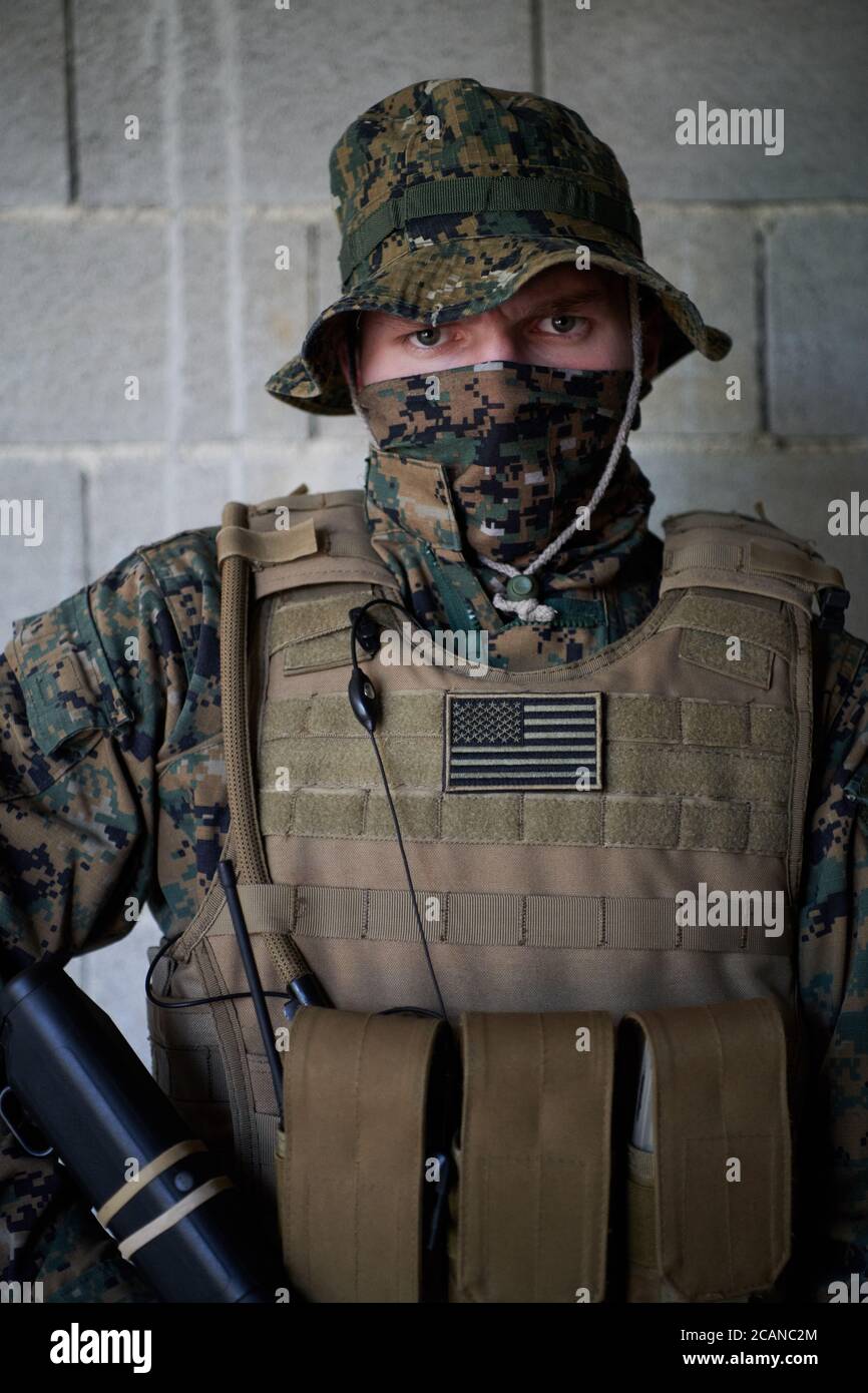 soldier portrait with protective army tactical gear against old