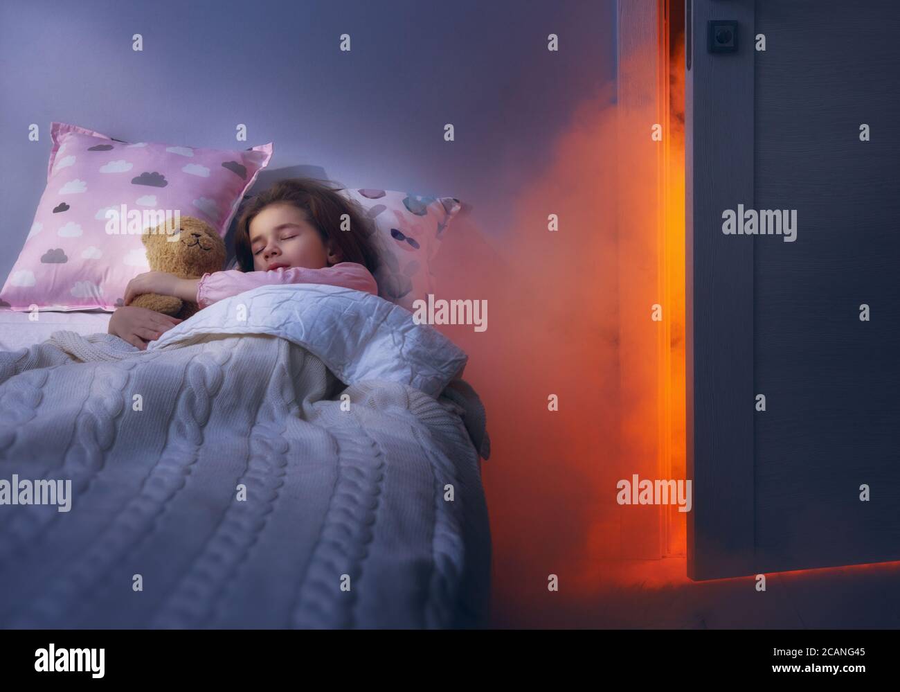 Nightmare for children. Little child girl is afraid of monsters in the dark of night. Stock Photo