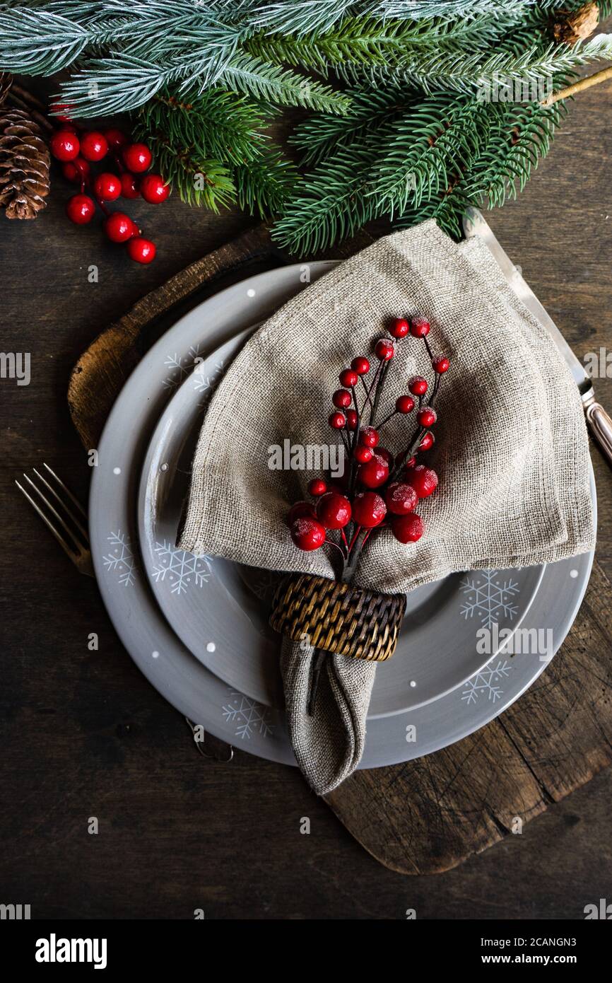 Christmas table setting with holiday decor on rustic table with copy space Stock Photo