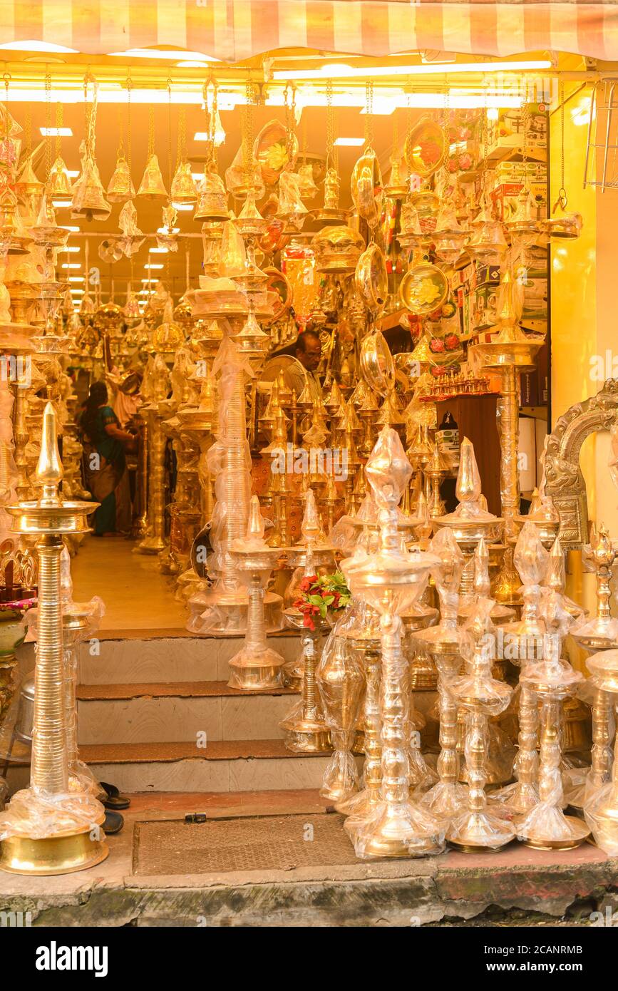 Kerala, India. September 07, 2019. Many big golden brass oil lamps at shop on the street Chalai Bazaar Kizhakkekotta Thiruvananthapuram or Trivandrum. Stock Photo
