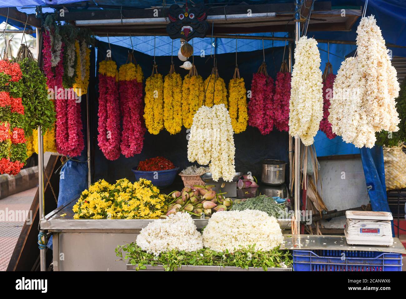 Kerala, India. September 07, 2019. Flower shop on the street at Chalai Bazaar Thiruvananthapuram or Trivandrum. Many garlands hanging in the shop Stock Photo