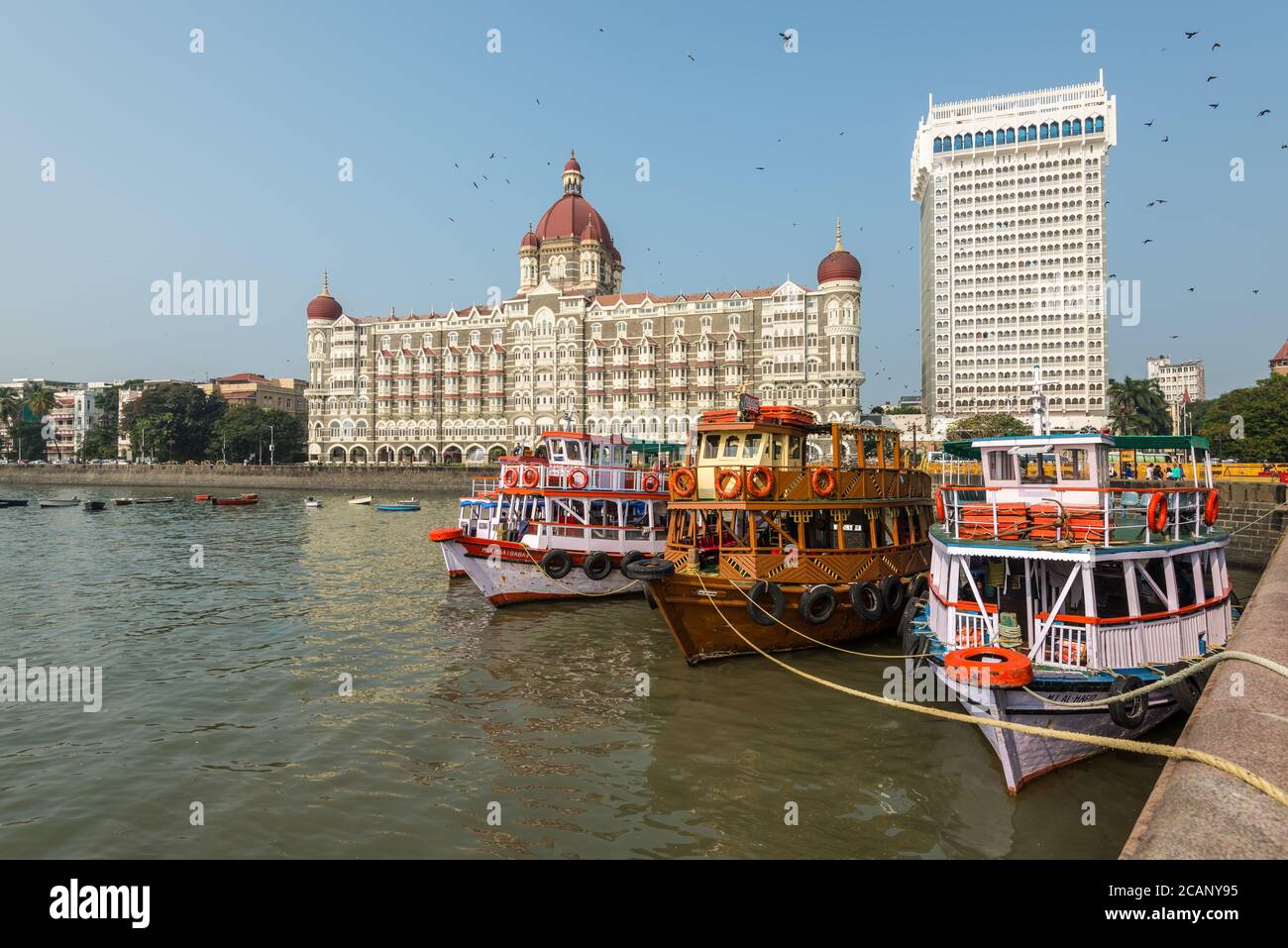 Mumbai, India - November 22, 2019: Taj Mahal Palace and tourist boats as seen from the Mumbai Harbour in Mumbai (colloquially known as Bombay), India. Stock Photo
