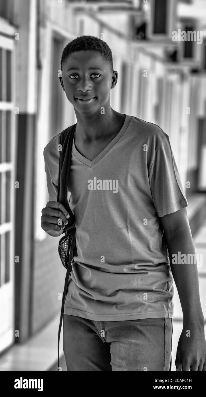 Happy african teenager boy returning to school. Back to school concept. Stock Photo